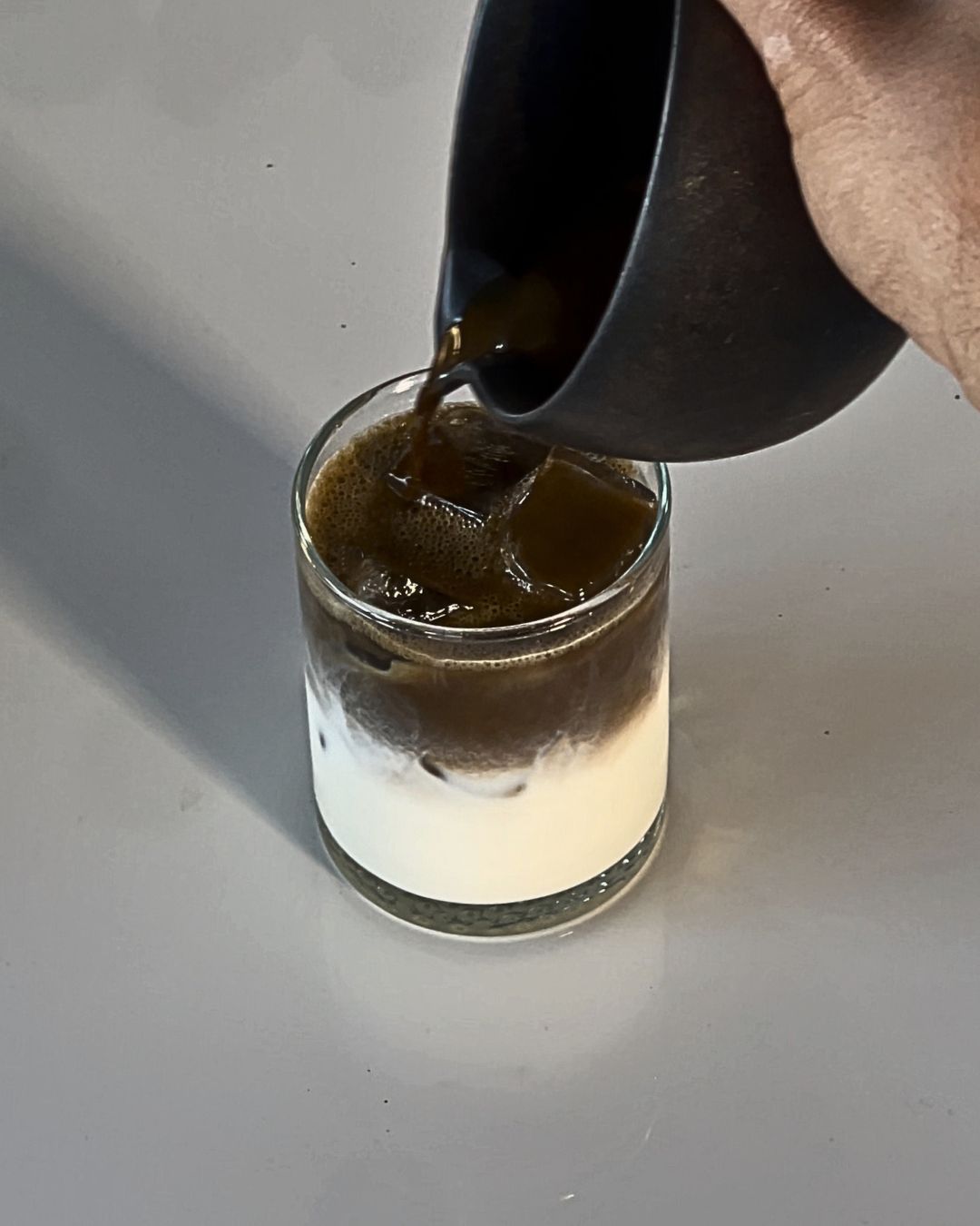 Hojicha poured into glass cup with milk