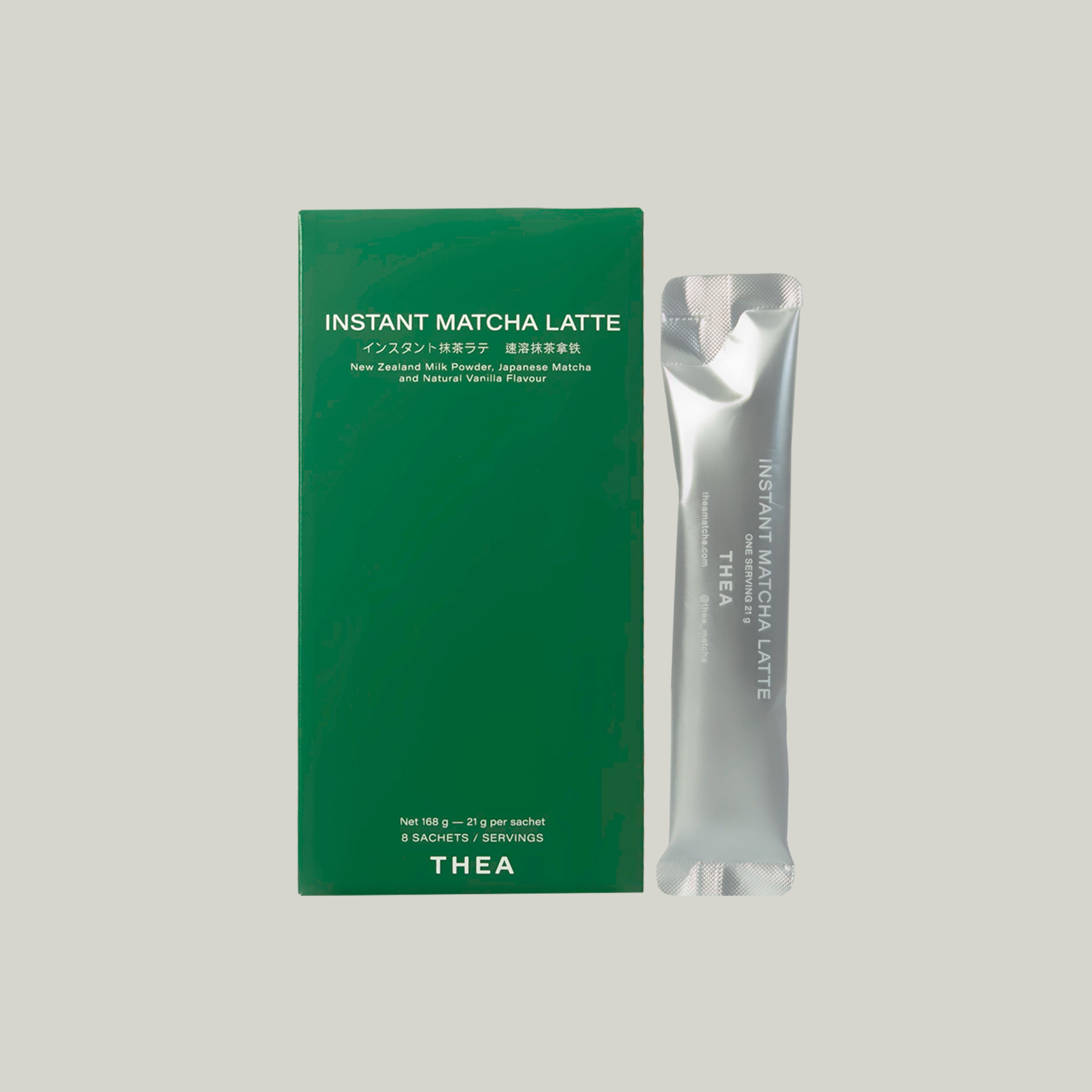 A green rectangular box labeled 'INSTANT MATCHA LATTE' stands next to a single silver sachet with matching text, on a plain light gray background. The box also shows 'THEA' near the bottom.