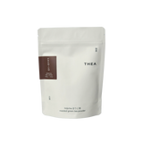 White pouch of THEA hojicha roasted green tea powder on a white background 100g